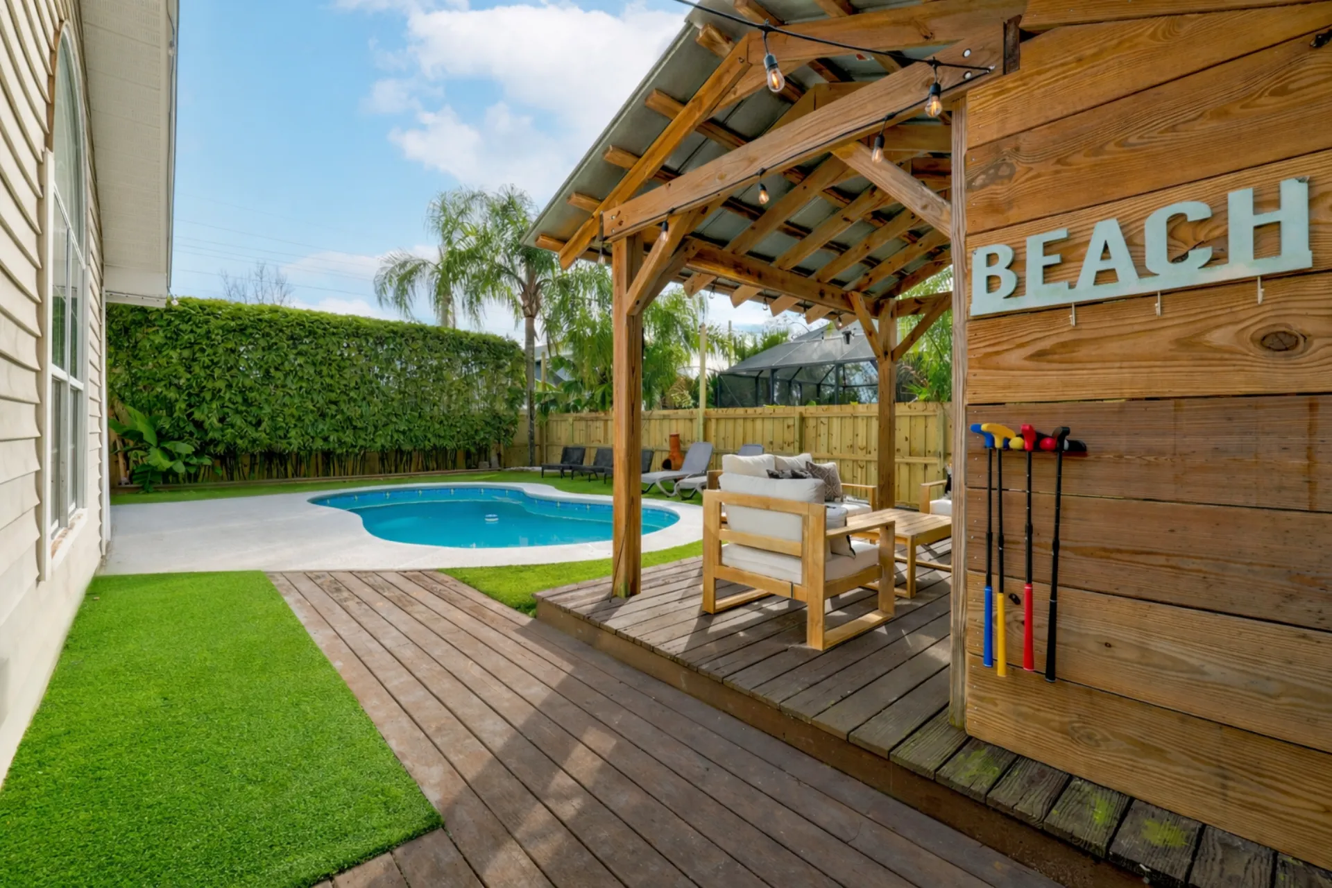 Private pool and deck area with pergola seating at Jacksonville Beach vacation rental